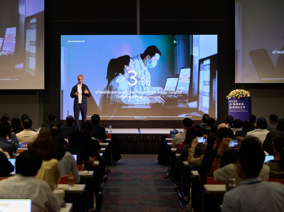 Jan Beger on stage in Taiwan beside a slide reading 3% of healthcare data is used to generate actual insights